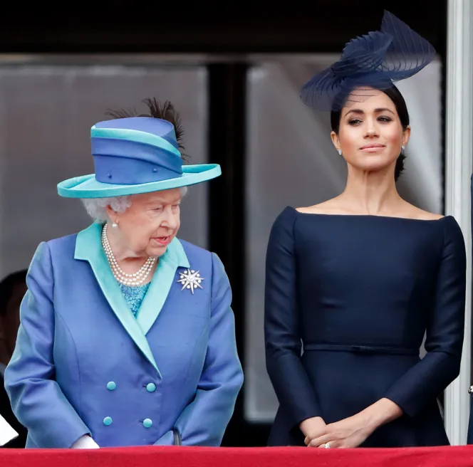 Queen Elizabeth II and Meghan, Duchess of Sussex, watch a flypast from the balcony of Buckingham Palace.