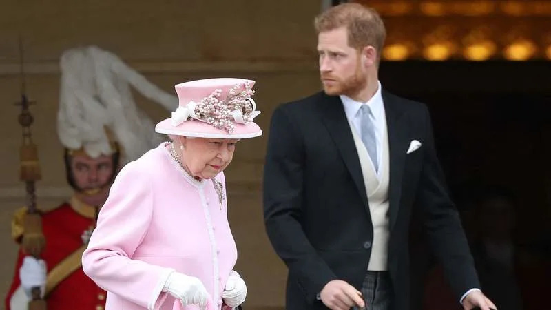 Queen Elizabeth II and Prince Harry attend a garden party at Buckingham Palace in 2019. By: MEGA