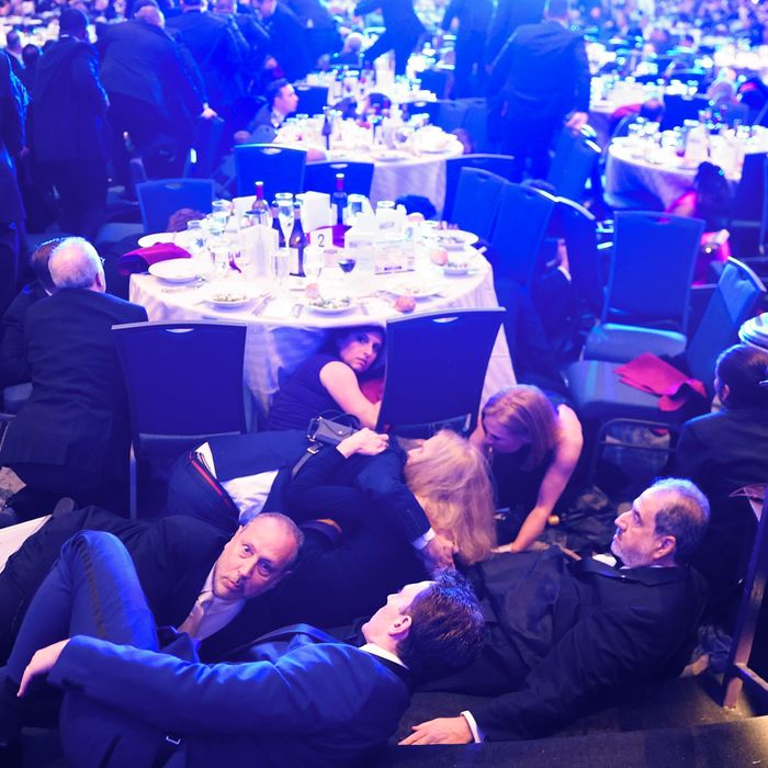 Guests at the White House Corresponds Dinner take cover after a shooting inside the Washington Hilton