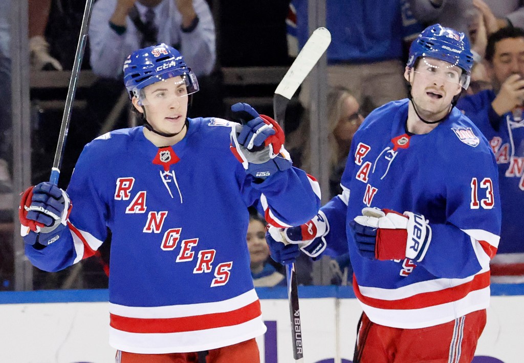 Gabe Perreault and Alexis Lafrenière of the New York Rangers celebrating a goal.
