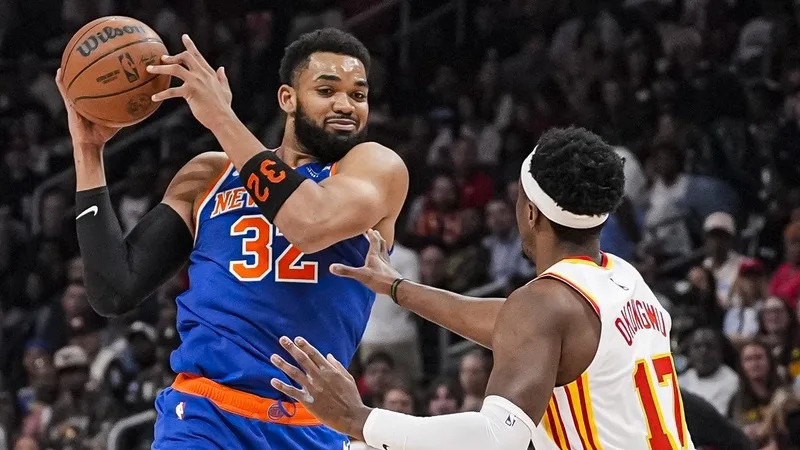 New York Knicks center Karl-Anthony Towns (32) works against Atlanta Hawks forward Onyeka Okongwu (17) during the first half at State Farm Arena.