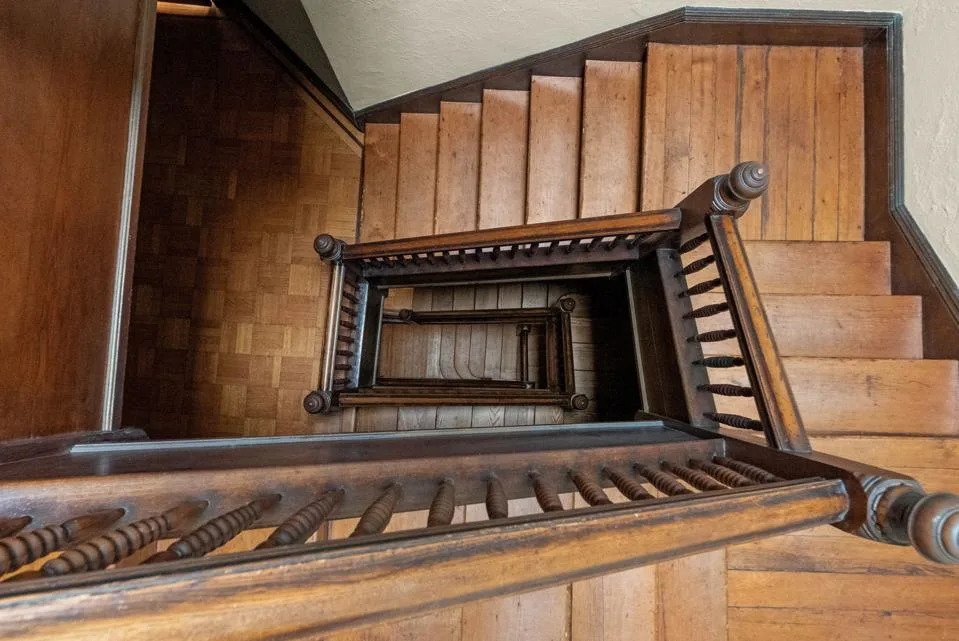 winding wooden staircase in Gilded Age Brooklyn brownstone home