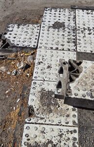 Bus stop along 21st Street with broken pieces of the “islands.”