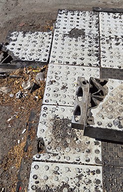 Bus stop along 21st Street with broken pieces of the “islands.”