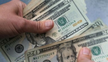 hands count 20-dollar bills
