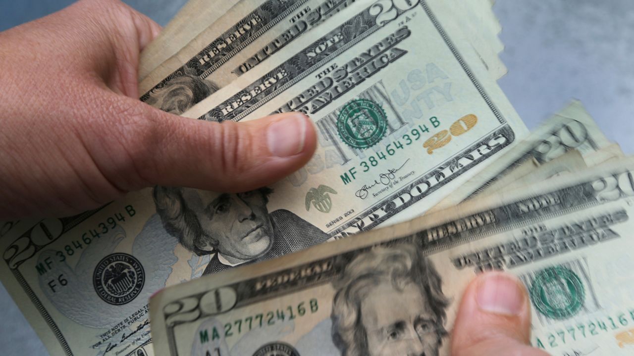 hands count 20-dollar bills
