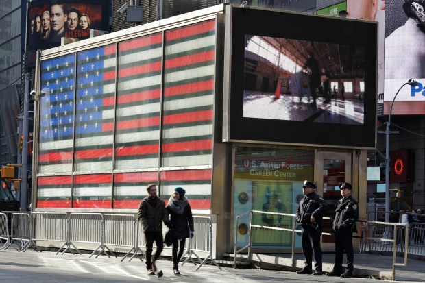 FILE - NYPD police officers are pictured outside the Armed Forces recruitment center in New York's Times Square in this file photo. (AP Photo/Mary Altaffer)