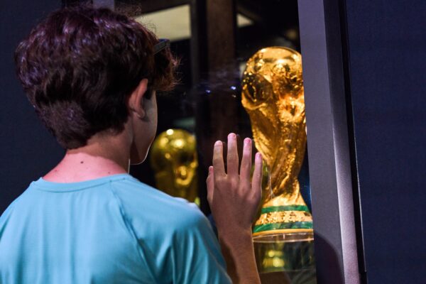 A youth looks at the FIFA World Cup trophy during an exhibition in Buenos Aires, Argentina, Friday, Feb. 20, 2026. Photo: Rodrigo Abd/AP