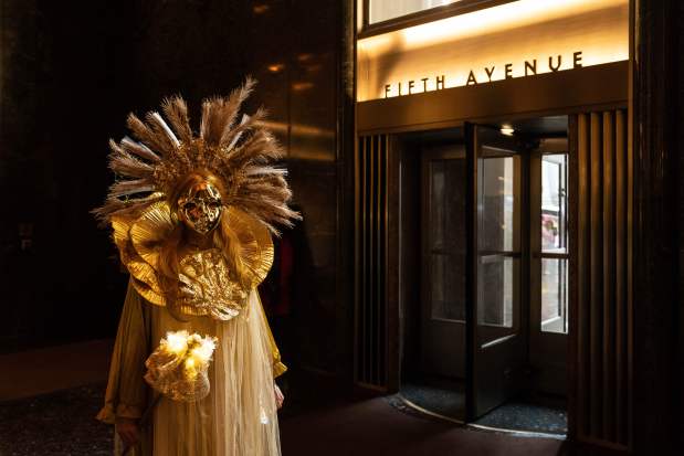 Henrieta Scholtzova stands inside Rockefeller Center during the Easter Bonnet Parade on Fifth Avenue, Sunday, April 5, 2026, in New York. (AP Photo/Adam Gray)