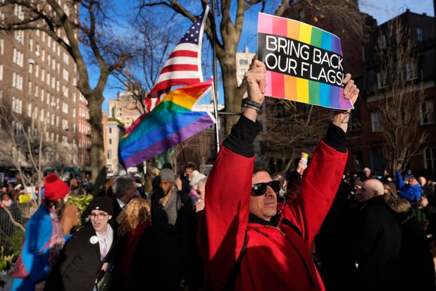 People demonstrate after New York politicians and activists raised a rainbow flag on a pole across the street from the Stonewall Inn