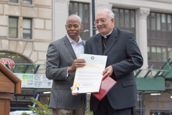 During the early years of this observance, it was called Brooklyn Day of Prayer, and elected leaders took an active role. Then-Borough President Eric Adams presents a Proclamation to Bishop Nicholas DiMarzio of the Roman Catholic Diocese of Brooklyn in this 2017 Brooklyn Eagle photo. DiMarzio is now Bishop emeritus of Brooklyn. Photo: Francesca N.Tate/Brooklyn Eagle