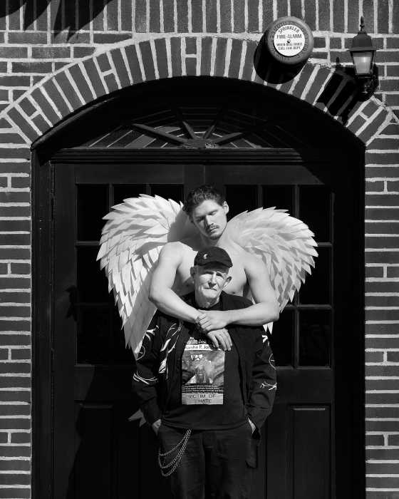 An angel embraces longtime LGBTQ activist Randy Wicker.