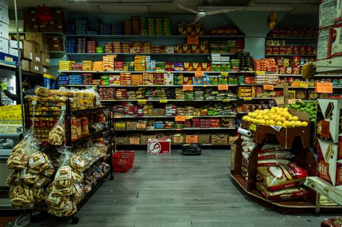 South Asian Spices, snacks, grains, and flours line the shelves at Al-Aqsa Supermarket in Bangla Bazaar.