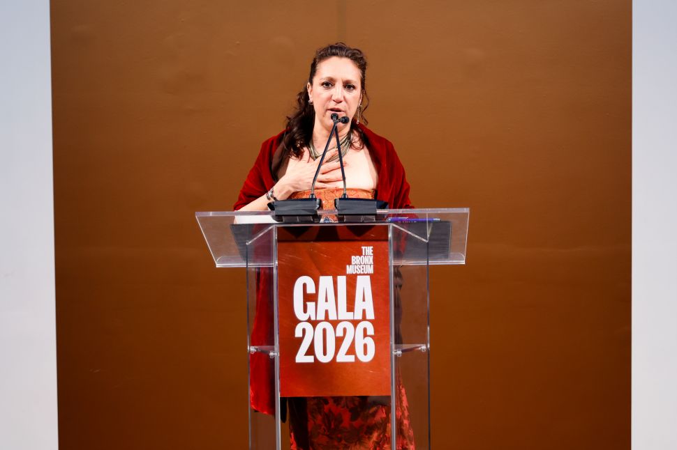 A woman speaking at a podium labeled “The Bronx Museum Gala 2026” against a warm-toned background.