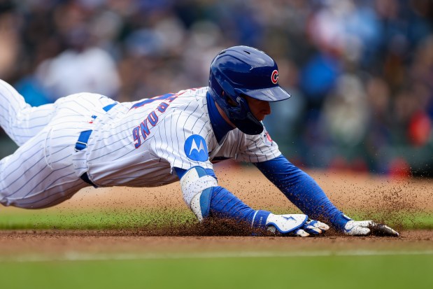Cubs center fielder Pete Crow-Armstrong (4) slides safely into third base after hitting a triple during the third inning against the Mets at Wrigley Field April 19, 2026, in Chicago. (Armando L. Sanchez/Chicago Tribune)