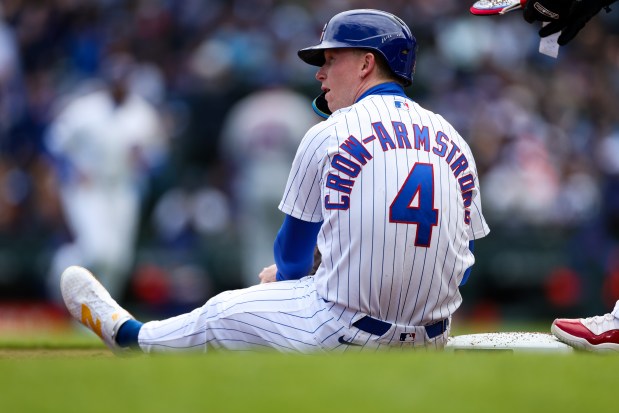 Cubs center fielder Pete Crow-Armstrong (4) sits on the ground after getting tagged out in a double play during the third inning against the Mets at Wrigley Field April 19, 2026, in Chicago. (Armando L. Sanchez/Chicago Tribune)