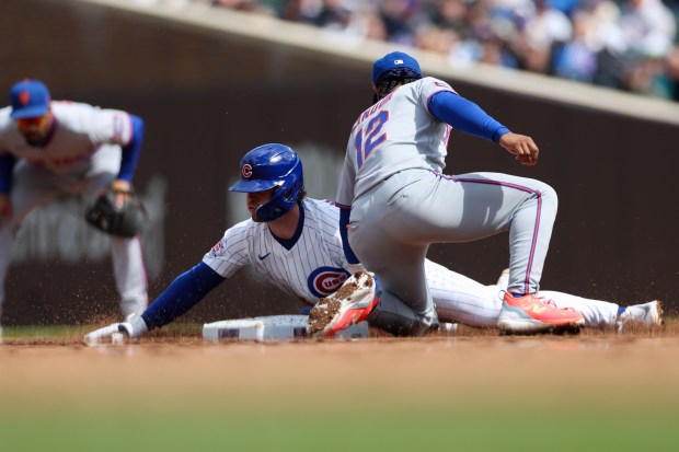 Cubs second baseman Nico Hoerner (2) steals second past Mets shortstop Francisco Lindor (12) during the sixth inning at Wrigley Field April 19, 2026, in Chicago. (Armando L. Sanchez/Chicago Tribune)