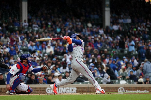 Mets shortstop Francisco Lindor (12) hits fly-out during the first inning against the Cubs at Wrigley Field April 19, 2026, in Chicago. (Armando L. Sanchez/Chicago Tribune)