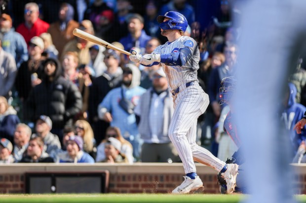 Cubs second baseman Nico Hoerner (2) hits a walk-off sacrifice fly bringing in Cubs center fielder Pete Crow-Armstrong (4) to give the Cubs a, 2-1, win over the Mets at Wrigley Field April 19, 2026, in Chicago. (Armando L. Sanchez/Chicago Tribune)