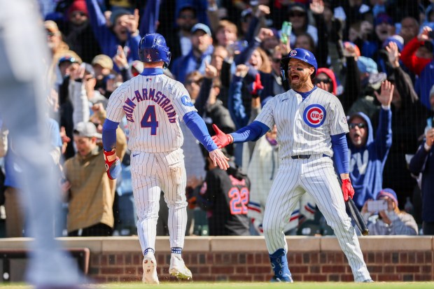 Cubs center fielder Pete Crow-Armstrong (4) celebrates with Cubs first baseman Michael Busch (29) after scoring off Cubs second baseman Nico Hoerner's (2) walk-off sacrifice fly to give the Cubs a, 2-1, win over the Mets at Wrigley Field April 19, 2026, in Chicago. (Armando L. Sanchez/Chicago Tribune)