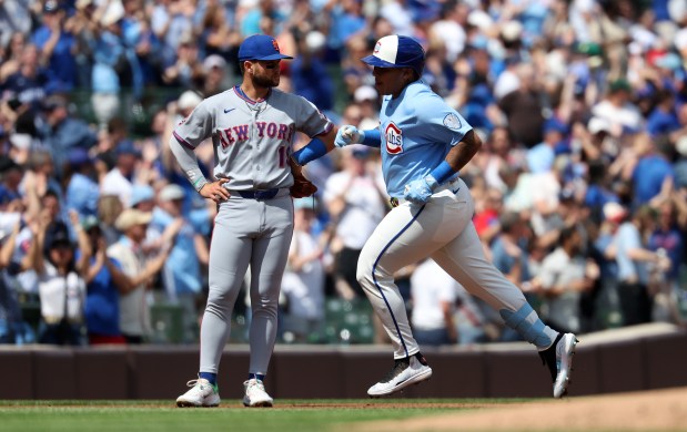 Chicago Cubs designated hitter Moisés Ballesteros (25) passes by New York Mets third baseman Bo Bichette (19) after Ballesteros hit a three-run homer in the first inning of a game at Wrigley Field in Chicago on April 17, 2026. (Chris Sweda/Chicago Tribune)