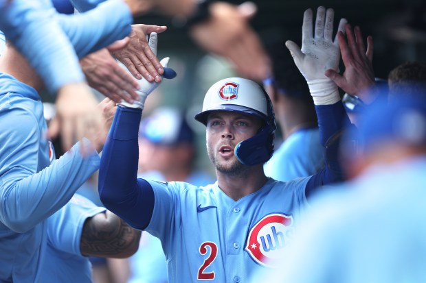 Chicago Cubs second baseman Nico Hoerner (2) is congratulated by his teammates in the dugout after hitting a two-run home run in the second inning of a game against the New York Mets at Wrigley Field in Chicago on April 17, 2026. (Chris Sweda/Chicago Tribune)