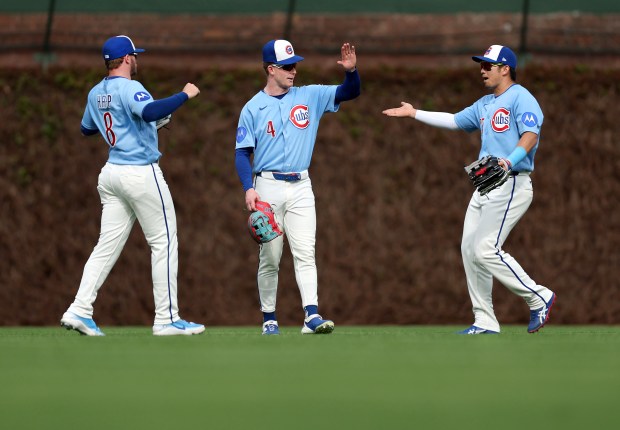 Chicago Cubs left fielder Ian Happ (8), center fielder Pete Crow-Armstrong (4), and right fielder Seiya Suzuki (right), celebrate after their victory over the New York Mets at Wrigley Field in Chicago on April 17, 2026. (Chris Sweda/Chicago Tribune)