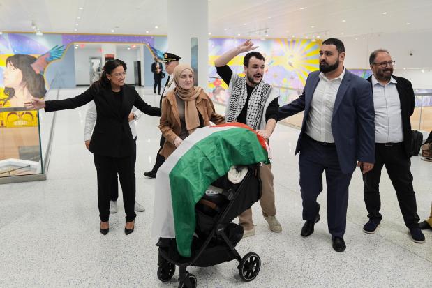 Mahmoud Khalil, center, reacts to supporters alongside his wife, Noor Abdallah, second from left, upon arriving at Newark International Airport, Saturday, June 21, 2025, after being released from a 104-day ICE detention in Louisiana. (AP Photo/Seth Wenig)