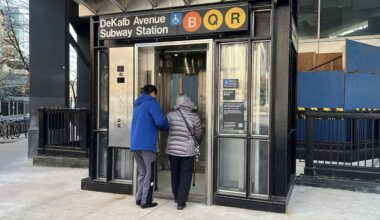 Riders at the DeKalb station elevator