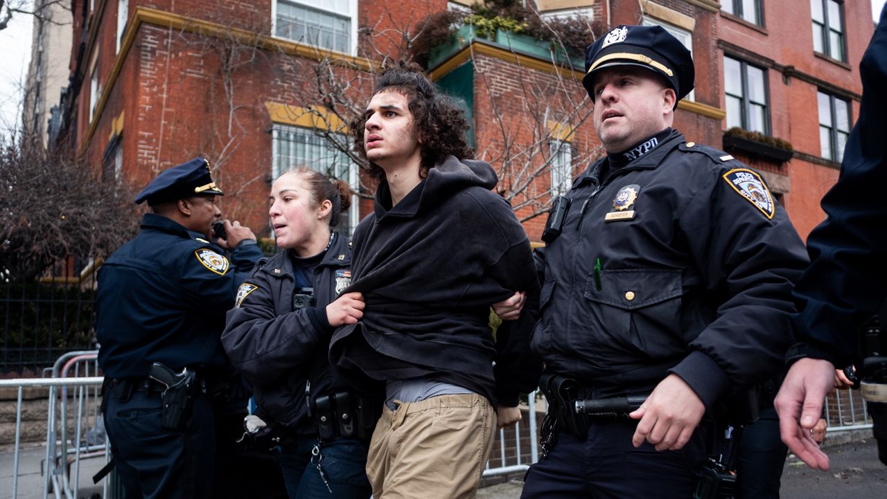 Police detain Emir Balat after he attempted to detonate an improvised explosive device during a counterprotest against far right influencer Jake Lang staging an anti-Islam protest outside Gracie Mansion, Saturday, March 7, 2026, in New York. (AP Photo/Julius Constantine Motal)