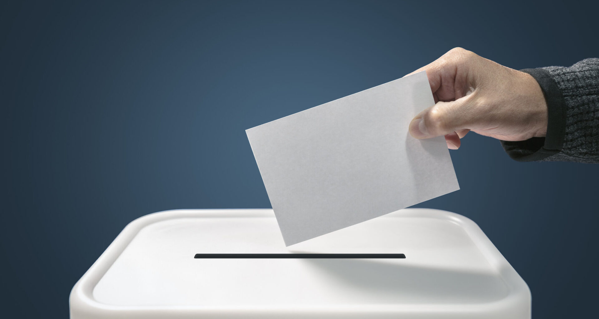 Man putting a ballot paper envelope into a voting box concept for election, freedom and democracy
