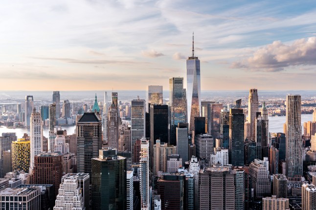 An aerial view of New York's Manhattan Financial District with One World Trade Center and many skyscrapers.
