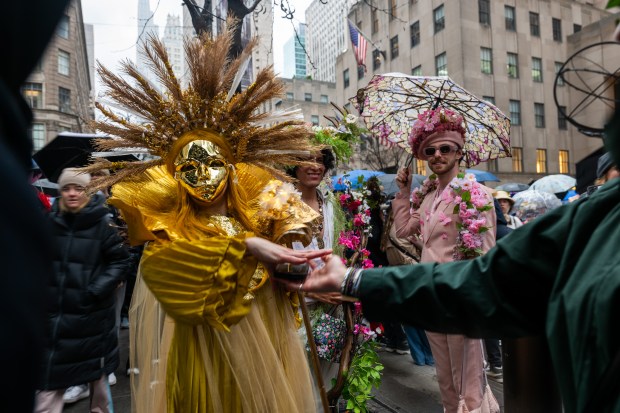 People dress in elaborate hats and costumes during the annual Easter Parade and Bonnet Festival outside of St. Patrick's Cathedral on Fifth Avenue on April 5, 2026 in New York City. (Photo by Spencer Platt/Getty Images)