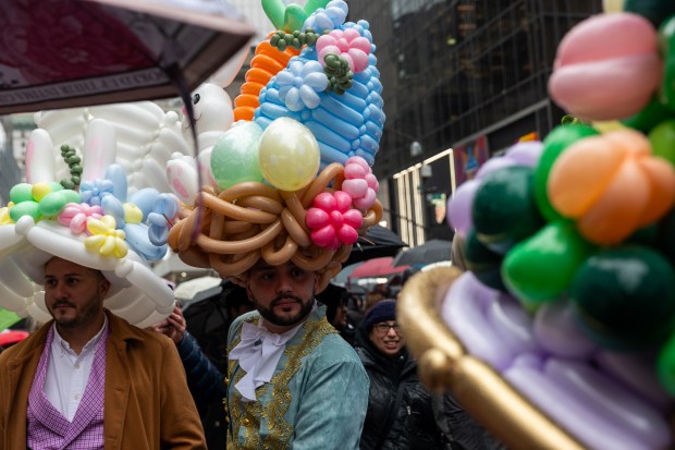 People dress in elaborate hats and costumes during the annual Easter Parade and Bonnet Festival outside of St. Patrick's Cathedral on Fifth Avenue on April 5, 2026 in New York City. (Photo by Spencer Platt/Getty Images)
