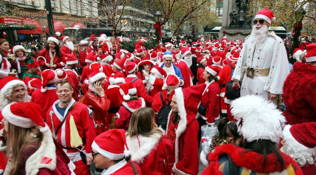 NEW YORK - DECEMBER 11: Hundreds of Santas stand in Herald Square while participating in the 2004 Santacon December 11, 2004 in New York City. The annual event occurs worldwide with hundreds of Santas in New York wandering through the city's bars, subways and tourist sites while generally wreaking havoc and speading holiday cheer. (Photo by Mario Tama/Getty Images)