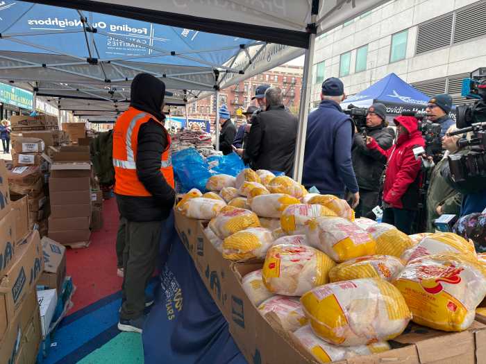 Volunteers from Catholic Charities distributed food on Thursday in Washington Heights ahead of the Easter holiday.