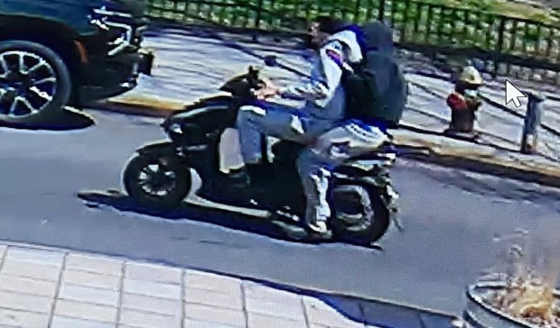 The shooter and his accomplice sped off north on Humboldt St., police sources said. The gunman has long hair and was wearing a light-colored hoodie while the other man had a dark-colored hoodie on. (Obtained by Daily News)