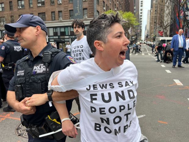 A protester is arrested during an anti-war demonstration outside the midtown Manhattan office of Sen. Chuck Schumer on Monday, April 13, 2026. 