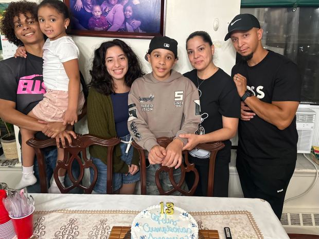 Jonathan Melo holding his little sister, left, with his older sister, younger brother, mother and father. (Courtesy of Family)