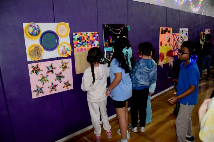 Students view art at the school silent disco party.