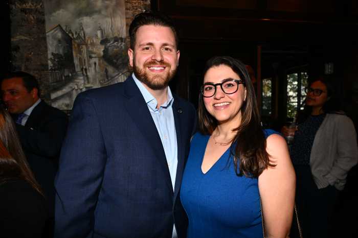 man in a suit jacket and woman in a blue dress
