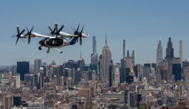 Joby Aviation eVTOL aircraft in flight above Lower Manhattan with One World Trade Center in the background