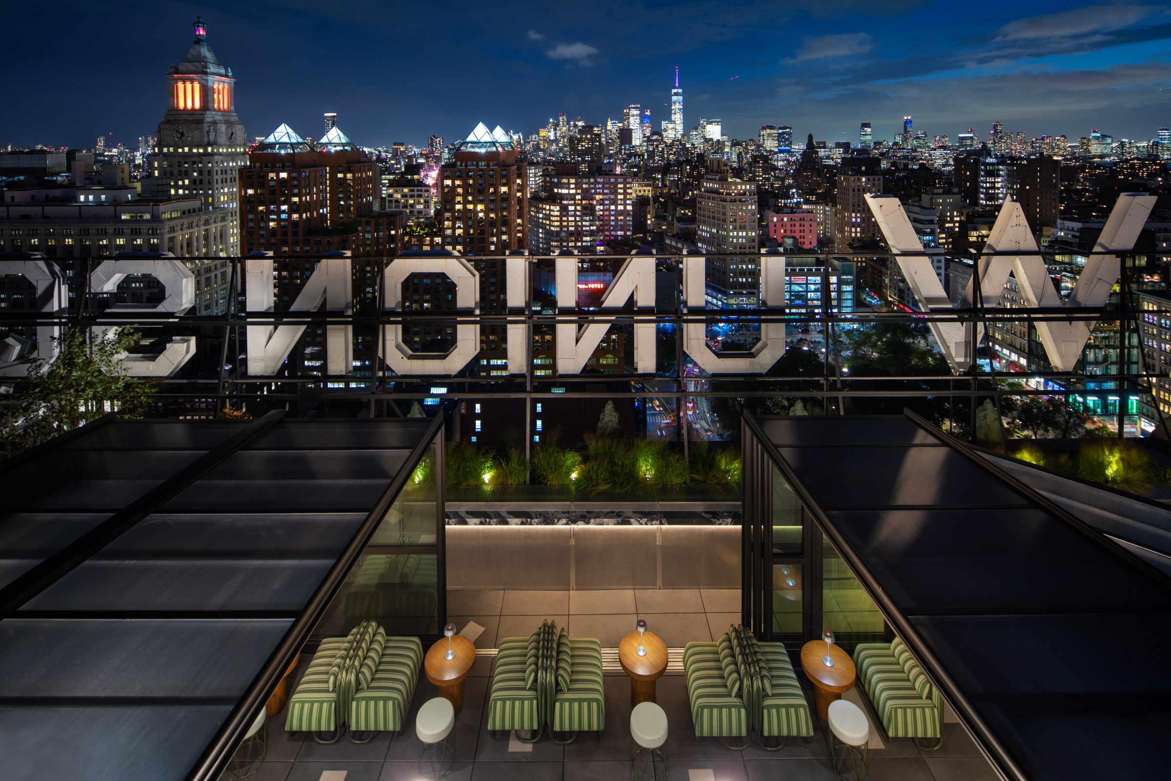 A rooftop bar with a city skyline view.