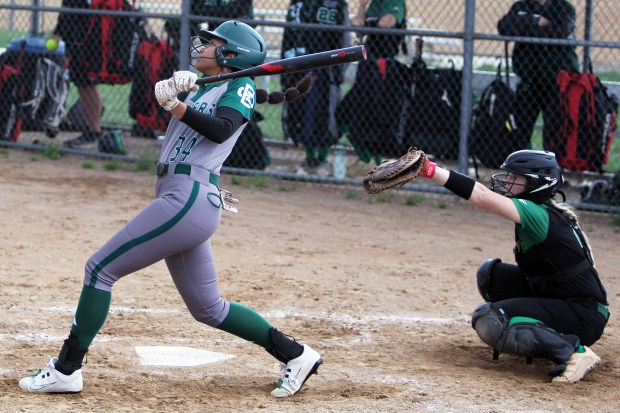 Elyria Catholic's Paytin Baehr hits a fly ball to right against Medina Highland on April 18. (Randy Meyers - for The Morning Journal)