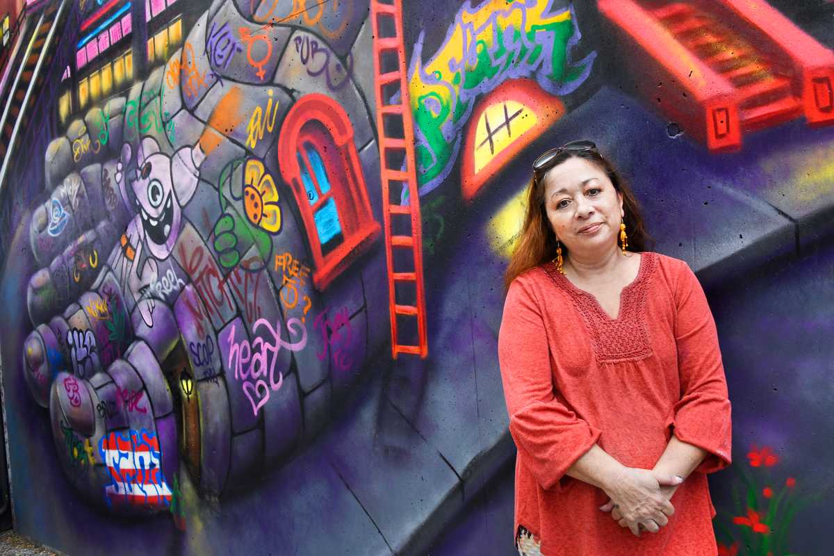 Lady Pink,  a legend of the New York City graffiti scene, in front of the mural she created for MoMA PS1.