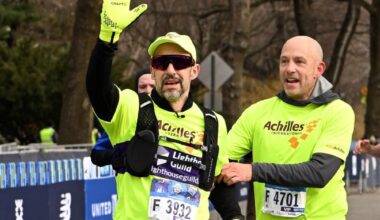 Blind runner Thomas Panek, finishing the NYC Half Marathon in Meta’s AI glasses. Beside him is his human guide, Jed Laskowitz. (Courtesy of Thomas Panek)