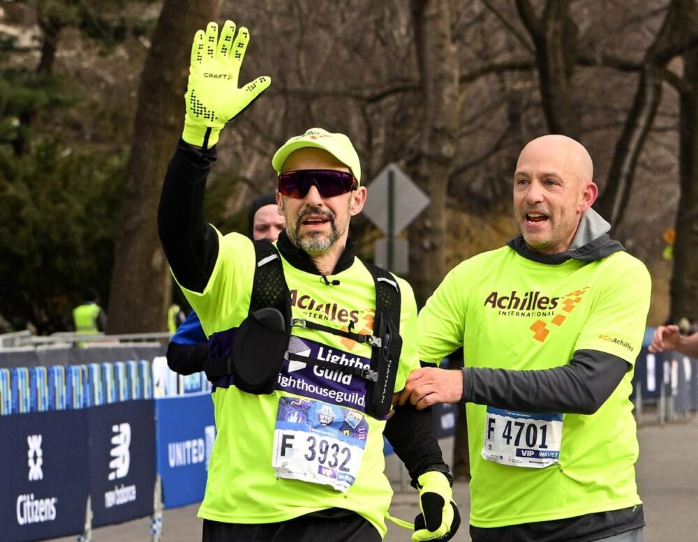 Blind runner Thomas Panek, finishing the NYC Half Marathon in Meta’s AI glasses. Beside him is his human guide, Jed Laskowitz. (Courtesy of Thomas Panek)