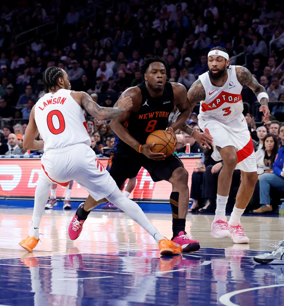 New York Knicks forward Og Anunoby drives to the basket between Toronto Raptors guard A.J. Lawson and Toronto Raptors forward Brandon Ingram during the first quarter in a game against the Toronto Raptors at Madison Square Garden in New York, New York, USA, Friday, April 10, 2026. 