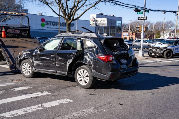 A driver in a black Subaru appeared to have been T-boned by NYPD officers rushing to respond to an assault when the vehicles collided at E. 18th St. and Avenue Y in Brooklyn on Saturday April 11, 2026. (Theodore Parisienne / New York Daily News)