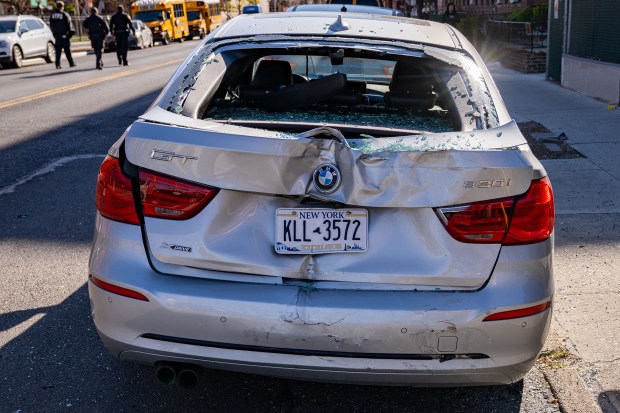 A parked silver BMW also wound up badly damaged due to the collision. (Theodore Parisienne / New York Daily News)